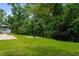 Lush backyard with mature trees, fire pit and view of deck at 2912 Vinings Forest Se Way, Atlanta, GA 30339