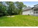 Well-manicured backyard featuring a fire pit and back porch at 2912 Vinings Forest Se Way, Atlanta, GA 30339