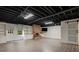 Finished basement with exposed ceiling, a brick fireplace, and laminate floors at 2912 Vinings Forest Se Way, Atlanta, GA 30339