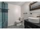 Stylish bathroom with modern vanity, a vessel sink, decorative mirror, and a shower with blue tile at 2912 Vinings Forest Se Way, Atlanta, GA 30339