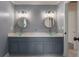 Stylish bathroom featuring dual vessel sinks, modern fixtures, and round decorative mirrors at 2912 Vinings Forest Se Way, Atlanta, GA 30339
