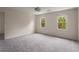 Bright bedroom with neutral carpet, fan lighting, and large windows at 2912 Vinings Forest Se Way, Atlanta, GA 30339