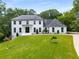 Charming two-story painted brick home featuring a well-manicured lawn and black trim windows at 2912 Vinings Forest Se Way, Atlanta, GA 30339