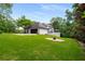 Manicured backyard with lush lawn, firepit, and exterior view of white house with black trim at 2912 Vinings Forest Se Way, Atlanta, GA 30339