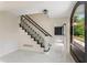 Elegant foyer showcasing a staircase with black banister and mosaic tile flooring at 2912 Vinings Forest Se Way, Atlanta, GA 30339