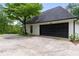 Attached garage with black door and long driveway at 2912 Vinings Forest Se Way, Atlanta, GA 30339