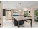 Bright kitchen featuring island with granite countertop and white tile backsplash at 2912 Vinings Forest Se Way, Atlanta, GA 30339