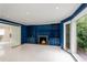 Cozy living room featuring custom blue built-in shelving, fireplace, and natural light at 2912 Vinings Forest Se Way, Atlanta, GA 30339