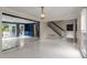 Open-concept living space featuring marble floors, staircase, and access to outdoor balcony at 2912 Vinings Forest Se Way, Atlanta, GA 30339