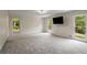Spacious living room featuring plush gray carpet and natural light from three large windows at 2912 Vinings Forest Se Way, Atlanta, GA 30339