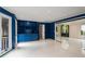 Bright living room with custom blue built-in shelving and sliding glass doors to adjacent spaces at 2912 Vinings Forest Se Way, Atlanta, GA 30339