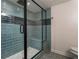 Elegant shower with modern fixtures, blue tiling, glass door, and built-in bench at 2912 Vinings Forest Se Way, Atlanta, GA 30339