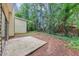 Backyard with concrete patio and mature trees at 6350 Mozart Dr, Riverdale, GA 30296