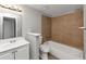 The bathroom features tile surround in the shower and tub area, neutral paint and tile flooring at 6350 Mozart Dr, Riverdale, GA 30296