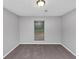Bedroom offers neutral carpet and ample natural light from a backyard window at 6350 Mozart Dr, Riverdale, GA 30296