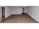 Bedroom featuring laminate floors, neutral grey walls, base molding, and access to a closet at 6350 Mozart Dr, Riverdale, GA 30296