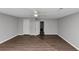 Spacious primary bedroom with laminate floors, a ceiling fan, gray walls and a walk in closet at 6350 Mozart Dr, Riverdale, GA 30296