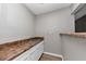 Butler's pantry featuring laminate countertops, white cabinets and stainless steel sink at 6350 Mozart Dr, Riverdale, GA 30296