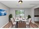 Charming dining room with seating for six, modern décor, and bright natural light at 6350 Mozart Dr, Riverdale, GA 30296