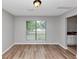 Bright dining room with wood-look floors, a large window and a connection to a butler's pantry at 6350 Mozart Dr, Riverdale, GA 30296