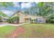 Traditional home with stone accents and a neat lawn, surrounded by mature trees at 6350 Mozart Dr, Riverdale, GA 30296
