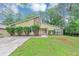 Charming home with a well-maintained lawn, complemented by lush greenery and trees at 6350 Mozart Dr, Riverdale, GA 30296