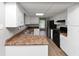 Kitchen boasts new flooring, white cabinets, and black appliances at 6350 Mozart Dr, Riverdale, GA 30296