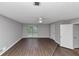 Open-plan living room features hardwood-style floors, grey walls and modern ceiling fan and plenty of natural light at 6350 Mozart Dr, Riverdale, GA 30296