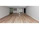 Spacious living room with wood floors, large windows, and a contemporary color palette at 6350 Mozart Dr, Riverdale, GA 30296