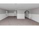 Spacious living room features neutral carpeting and white wainscoting at 6350 Mozart Dr, Riverdale, GA 30296