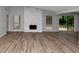 Bright and open living area with a stone fireplace and modern flooring at 6350 Mozart Dr, Riverdale, GA 30296