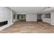 Expansive living room featuring hardwood floors, a stone fireplace, and neutral walls at 6350 Mozart Dr, Riverdale, GA 30296