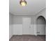 Small room features neutral carpeting and arched doorway at 6350 Mozart Dr, Riverdale, GA 30296