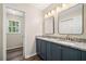 Modern bathroom featuring double vanity, stylish mirrors, and updated lighting at 1489 Kolb Ridge Sw Dr, Marietta, GA 30008
