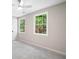 Bright bedroom with soft neutral walls features large windows for natural light and plush carpeting at 1489 Kolb Ridge Sw Dr, Marietta, GA 30008