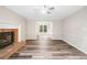 Spacious living room featuring hardwood floors and a cozy brick fireplace at 1489 Kolb Ridge Sw Dr, Marietta, GA 30008