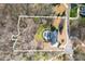 Aerial view of a luxurious property with a large lot, private pool, and surrounded by mature trees at 210 Little River Farms Trl, Canton, GA 30115