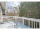 Back deck with table and chairs overlooking the wooded backyard at 210 Little River Farms Trl, Canton, GA 30115