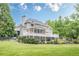 Back of house with multilevel decks, screened porch, and spacious backyard at 210 Little River Farms Trl, Canton, GA 30115
