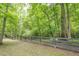 View of the lush backyard and a dark wooden fence at 210 Little River Farms Trl, Canton, GA 30115