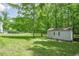 Spacious backyard with a storage shed at 210 Little River Farms Trl, Canton, GA 30115