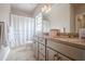 Bathroom with a double vanity, neutral tile flooring, and a shower/tub combo with a patterned curtain at 210 Little River Farms Trl, Canton, GA 30115