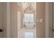 Spa bathroom with marble floors, vaulted ceilings, chandelier, and luxurious soaker tub at 210 Little River Farms Trl, Canton, GA 30115