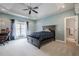 Large bedroom with tray ceiling, ceiling fan, and big window providing natural light at 210 Little River Farms Trl, Canton, GA 30115