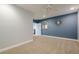 Spacious bedroom with neutral carpet, blue accent wall, and natural light at 210 Little River Farms Trl, Canton, GA 30115