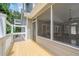 Wooden deck features access to both a screened porch and an outdoor balcony in a verdant, wooded backyard at 210 Little River Farms Trl, Canton, GA 30115