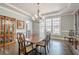 Formal dining room featuring hardwood floors, chandelier, and large windows at 210 Little River Farms Trl, Canton, GA 30115