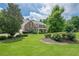 Beautiful home featuring manicured lawn, mature trees, and charming curb appeal at 210 Little River Farms Trl, Canton, GA 30115