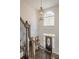 Bright foyer with staircase, arched window, and decorative front door at 210 Little River Farms Trl, Canton, GA 30115