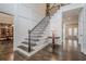 Elegant foyer with staircase and view to the dining and living room at 210 Little River Farms Trl, Canton, GA 30115